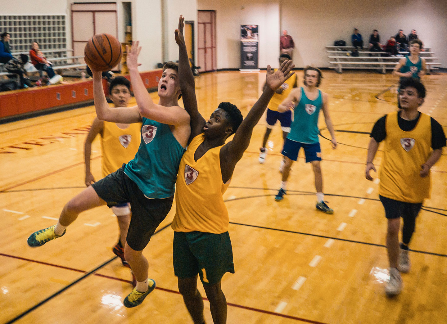 teen boys playing basketball